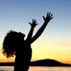 girl with outstretched arms to sky
