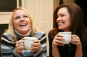 friends laughing and drinking coffee together