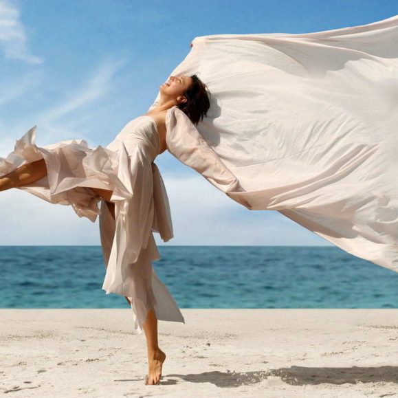 Woman dancing on the beach